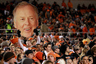 STILLWATER, OK - DECEMBER 03:  A fan holds an image of T. Boone Pickens before a game against the Oklahoma Sooners at Boone Pickens Stadium on December 3, 2025 in Stillwater, Oklahoma.  (Photo by Ronald Martinez/Getty Images)
